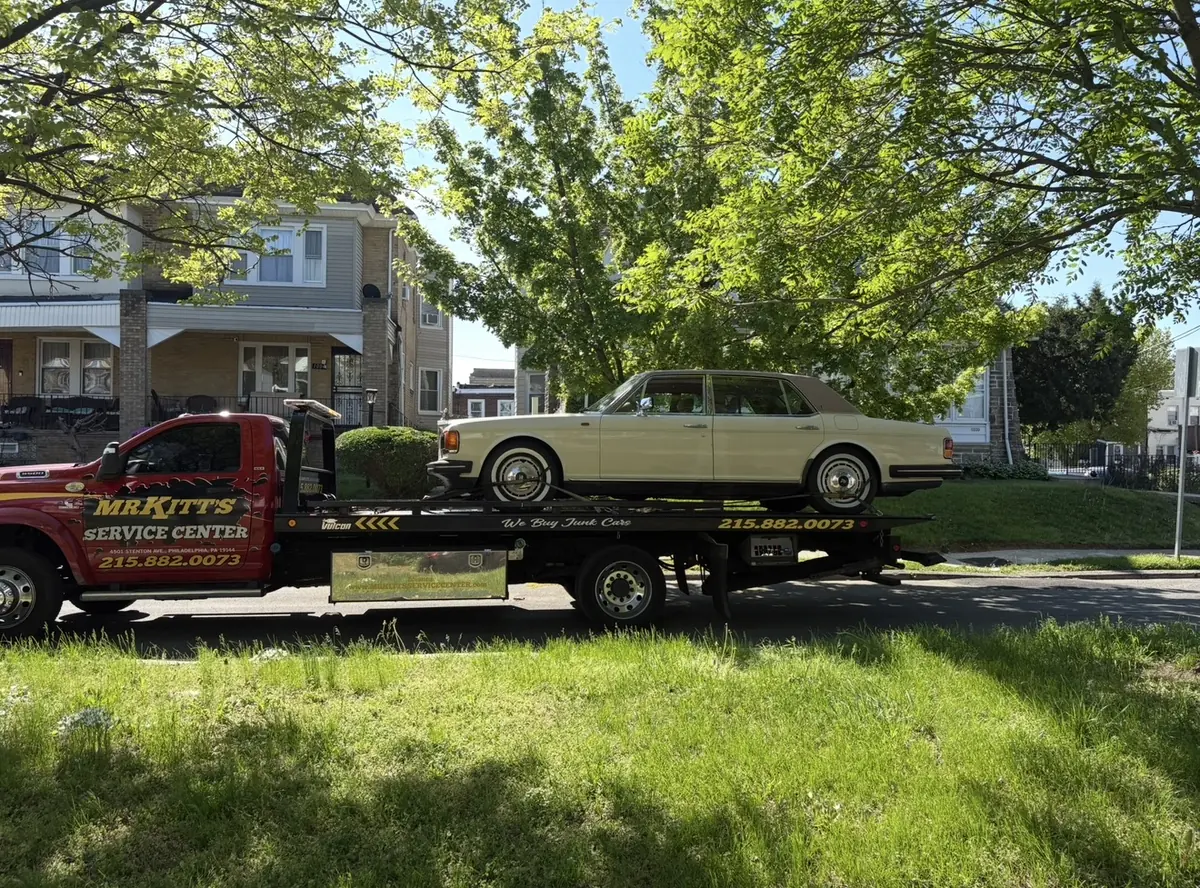 A classic car secured on a Mr. Kitt's flatbed