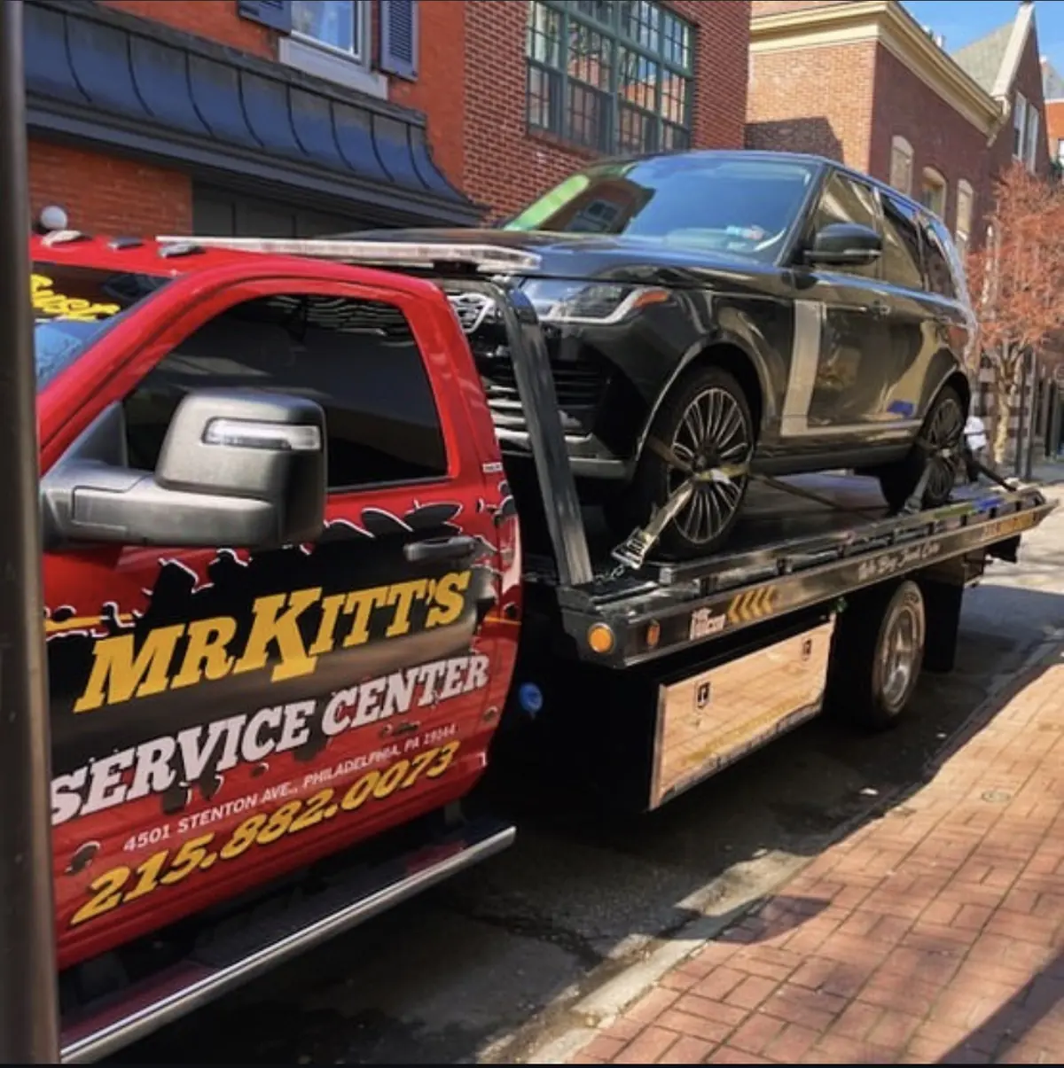 Gold Mr. Kitt's Service Center lettering on a red flatbed deck