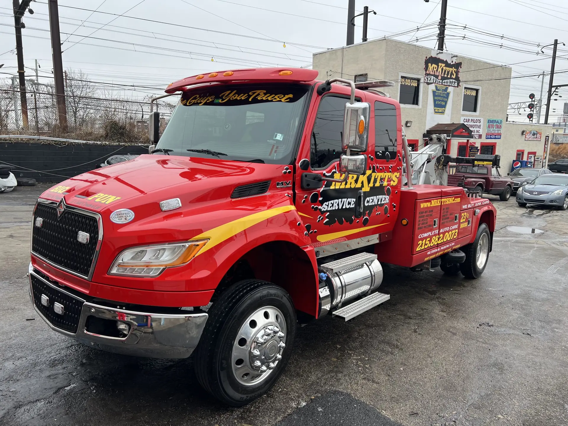 Mr. Kitt's red wrecker with gold lettering parked outside the Stenton Avenue shop