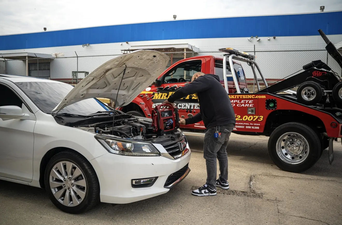 Technician working under the hood at Mr. Kitt's Service Center