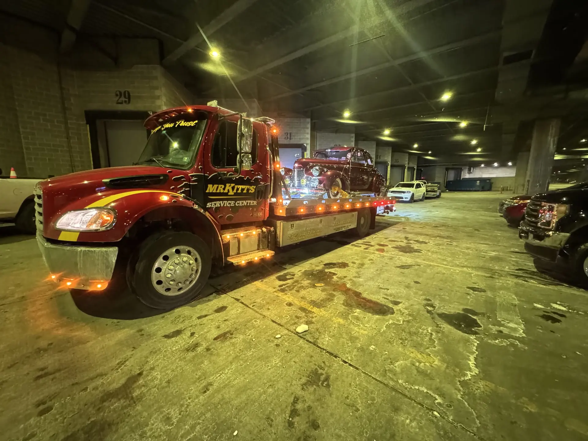 Mr. Kitt's wrecker lit up inside the garage at night