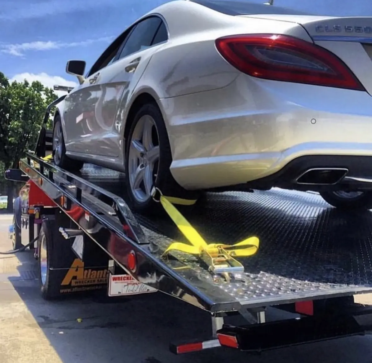 Luxury sedan secured on a Mr. Kitt's flatbed with soft straps