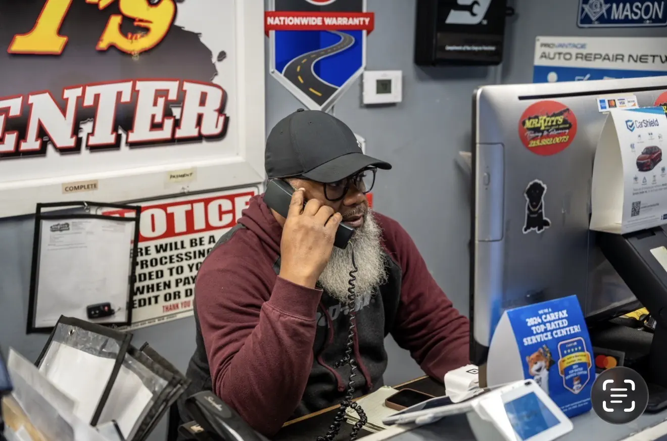 A Mr. Kitt's service advisor taking a call at the front counter