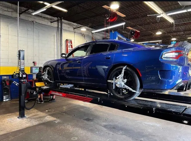 A Dodge Charger on the alignment rack at Mr. Kitt's