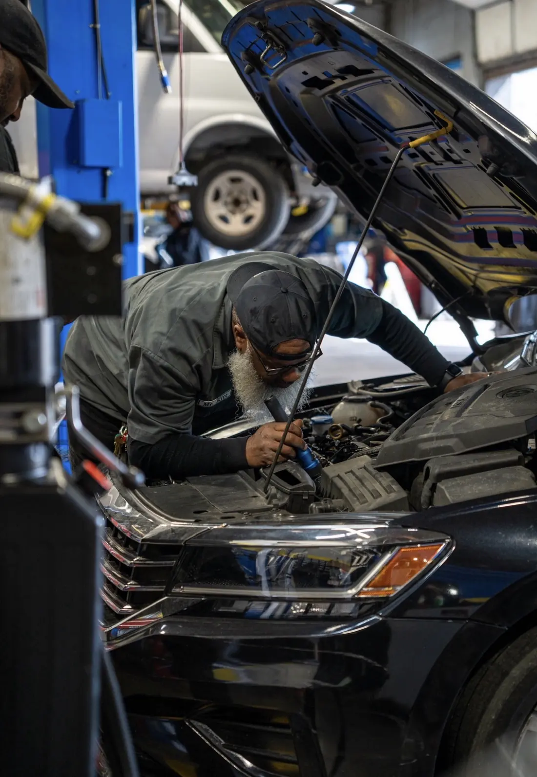 A Mr. Kitt's technician working in an open engine bay