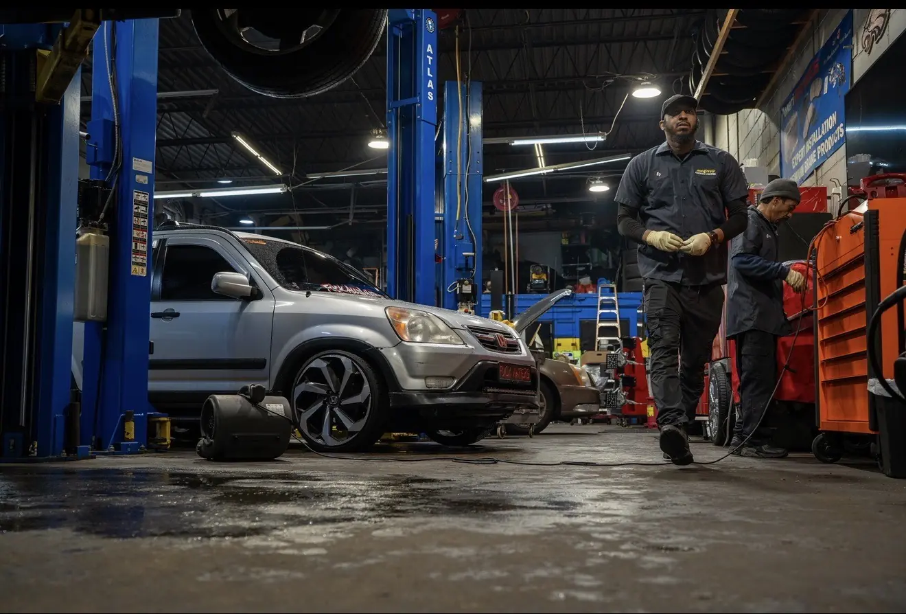The service bays at Mr. Kitt's on Stenton Avenue with vehicles up on the lifts