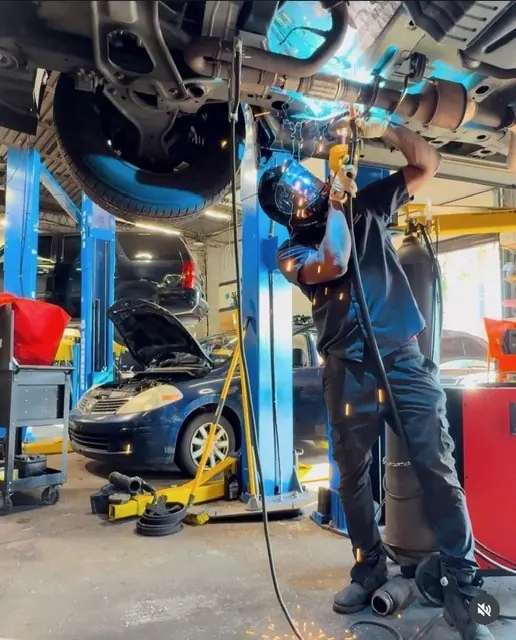 Exhaust and underbody welding on a car raised on the lift